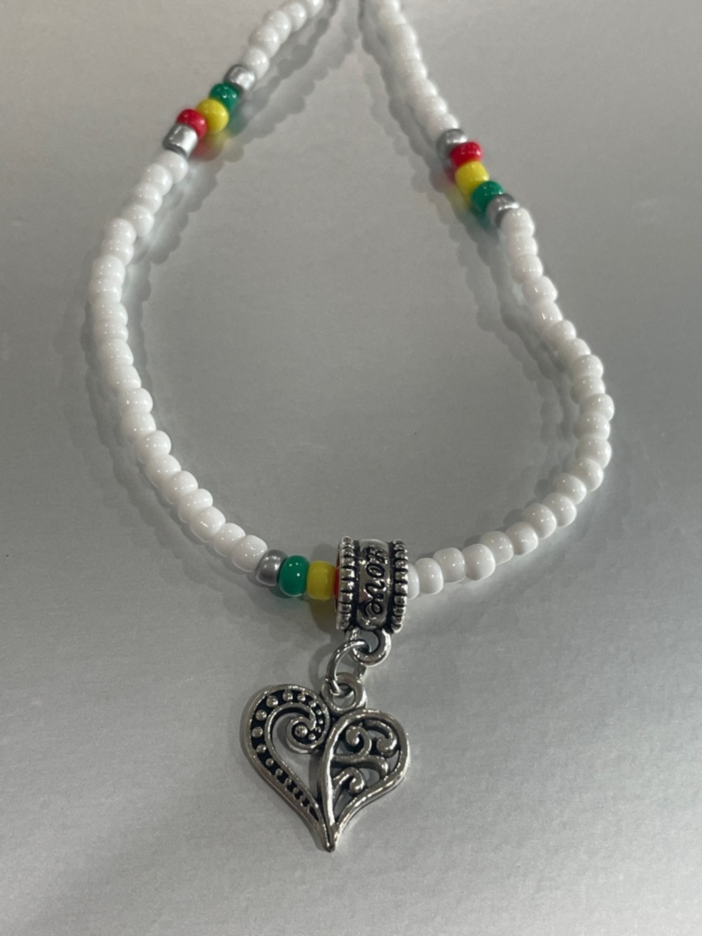 White Beaded Necklace with Silver Heart Charm and Multicolor Accents